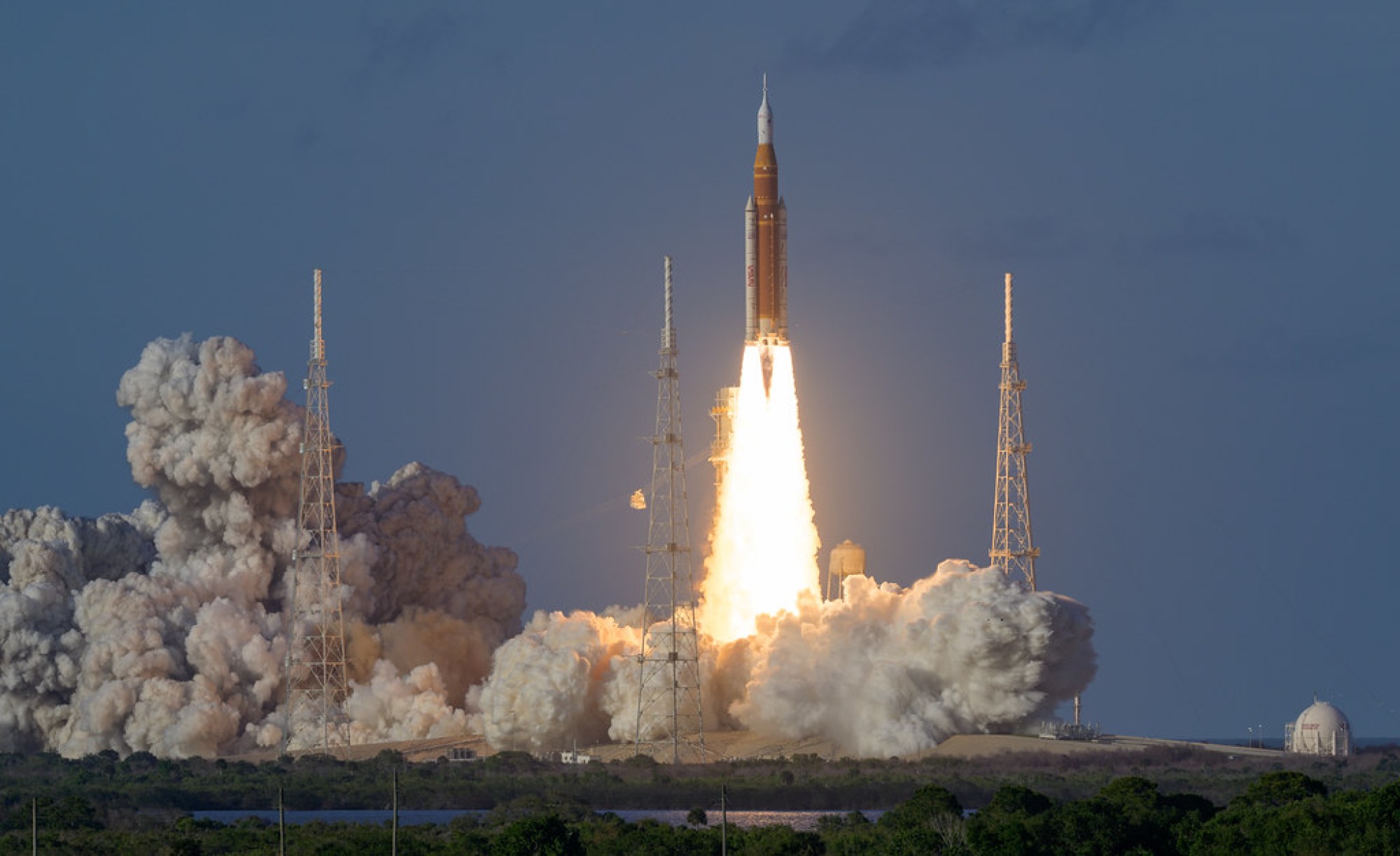 NASA SLS rocket lifting off with Artemis II from Kennedy Space Center.